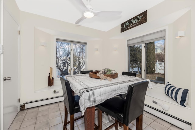 tiled dining space featuring a baseboard radiator and ceiling fan