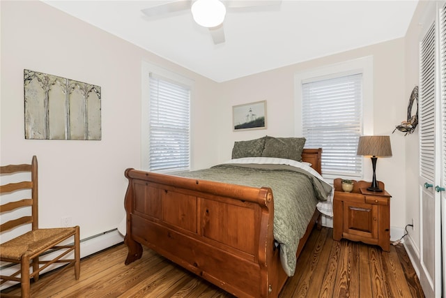 bedroom featuring hardwood / wood-style flooring, ceiling fan, and multiple windows