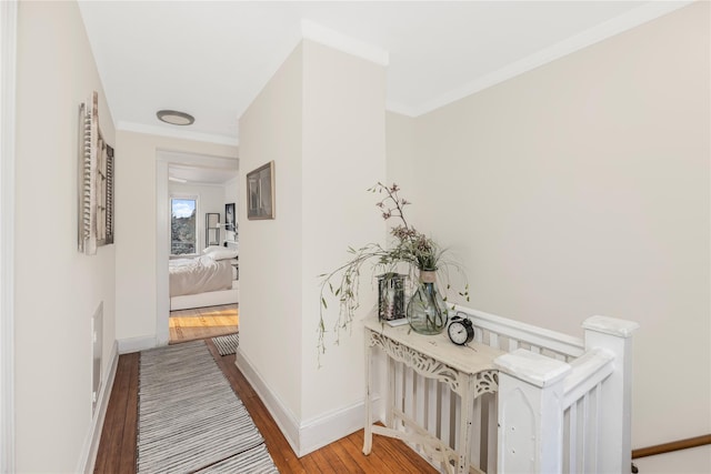 hall with crown molding and wood-type flooring