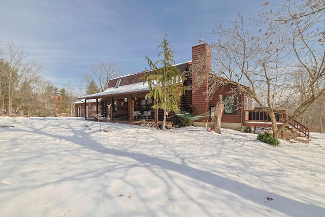 snow covered house with a chimney