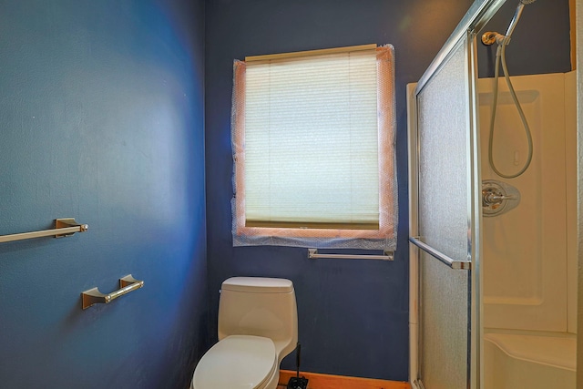 full bathroom with a shower stall and toilet