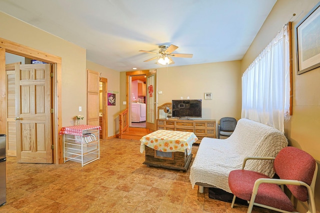 living room featuring ceiling fan and washer / clothes dryer