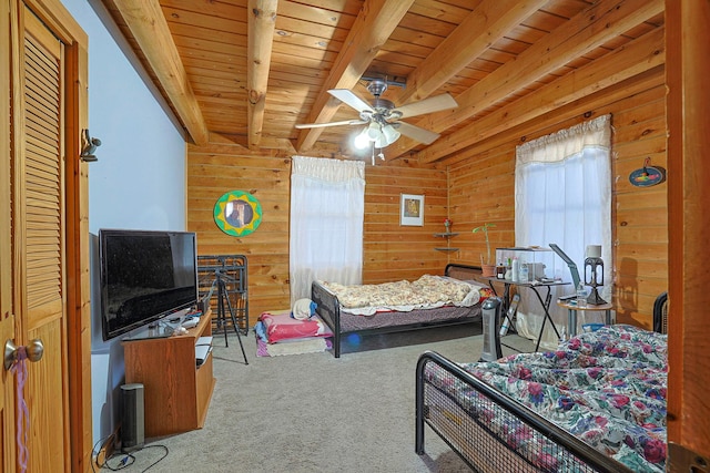 carpeted bedroom with wooden ceiling, wooden walls, and beam ceiling