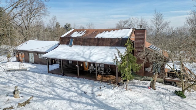 snow covered house with a chimney
