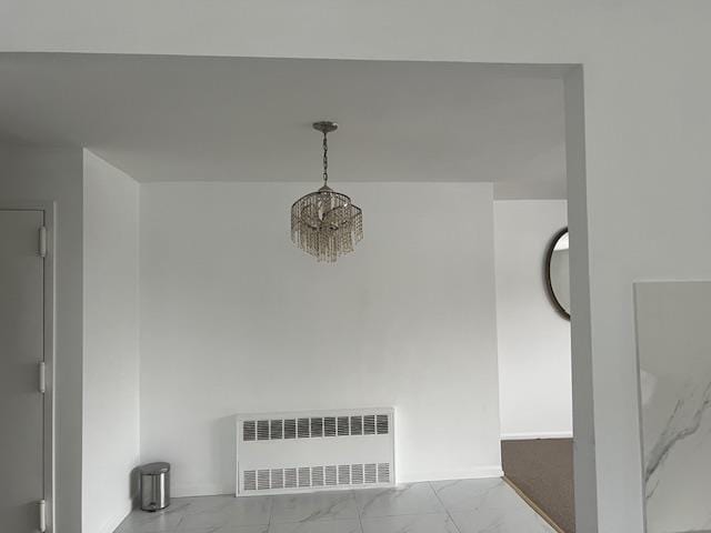 room details with an inviting chandelier and radiator heating unit