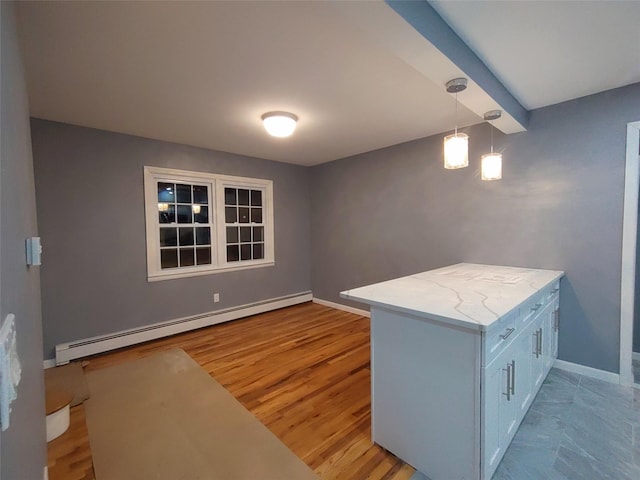 interior space featuring beam ceiling, light hardwood / wood-style floors, and baseboard heating