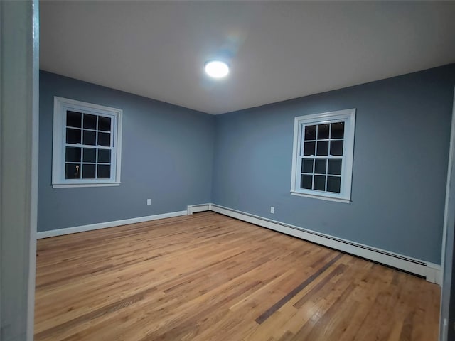 spare room with light hardwood / wood-style floors and baseboard heating