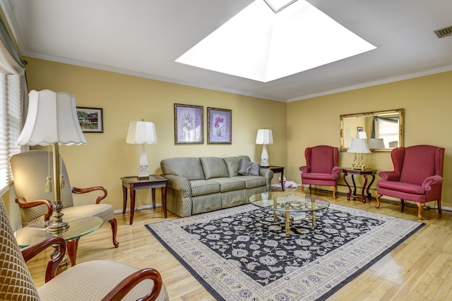 living room featuring crown molding, a skylight, and light wood-type flooring