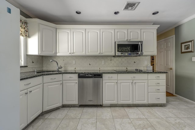 kitchen with sink, stainless steel appliances, dark stone counters, and white cabinets