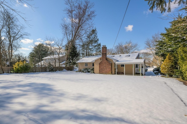 view of snow covered rear of property