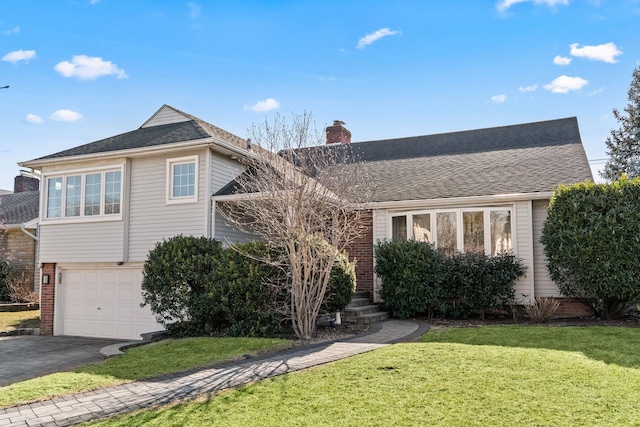 view of front of property featuring a garage and a front lawn