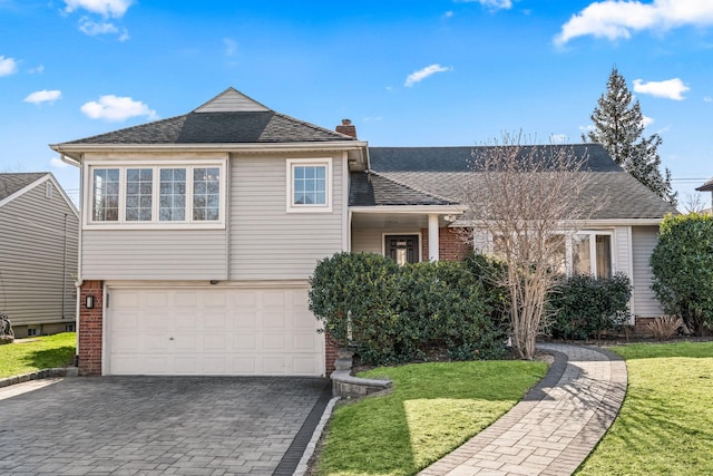 view of front of home featuring a garage and a front lawn