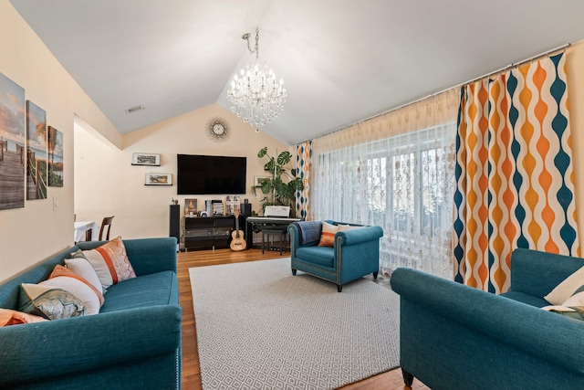 living room with hardwood / wood-style flooring, vaulted ceiling, and a notable chandelier