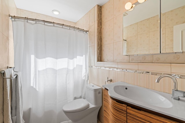 bathroom featuring vanity, toilet, a shower with shower curtain, and tile walls