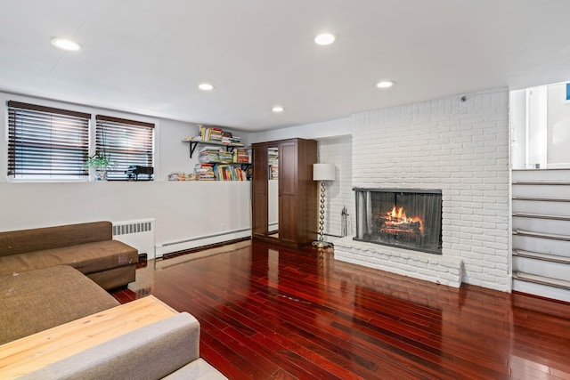 living area featuring recessed lighting, a fireplace, baseboard heating, radiator, and hardwood / wood-style floors