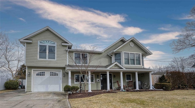 view of front of house with a garage, a front yard, and covered porch