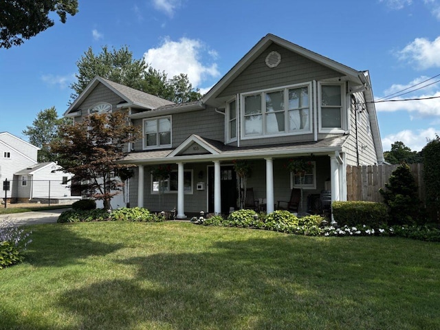 view of front facade with covered porch and a front yard