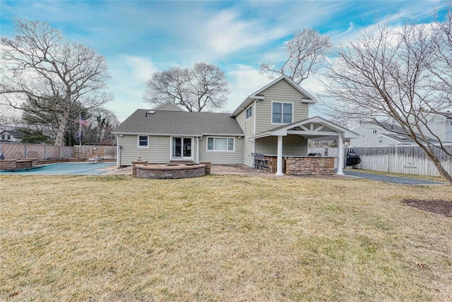 rear view of house with a yard, a patio area, and a bar