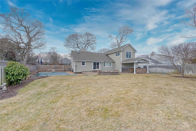 back of property featuring a yard and a patio area