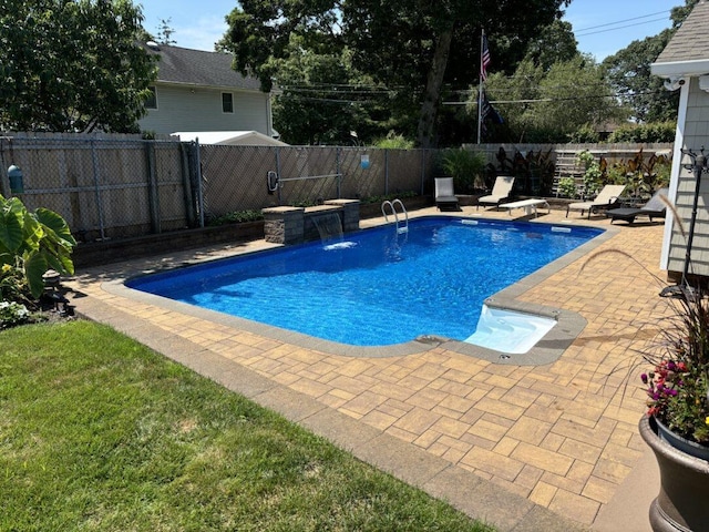 view of swimming pool featuring pool water feature and a patio