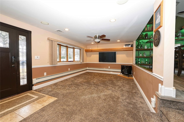 interior space featuring a baseboard radiator, ceiling fan, and carpet