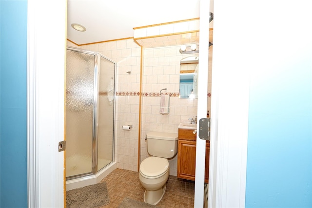 bathroom featuring tile walls, vanity, walk in shower, toilet, and tile patterned floors