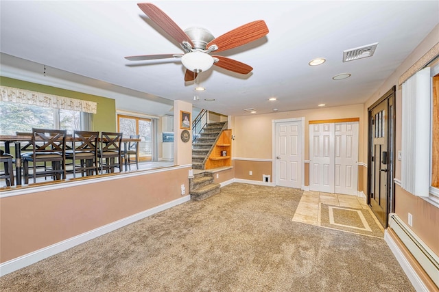 interior space with carpet floors and baseboard heating