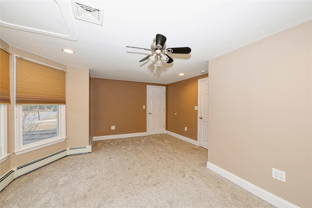 empty room featuring ceiling fan, light carpet, and a baseboard heating unit