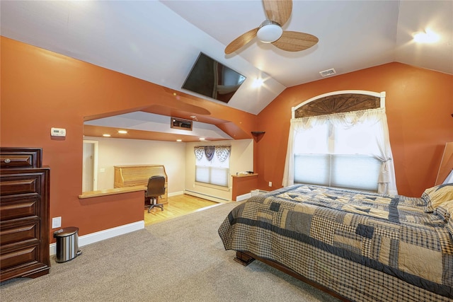 carpeted bedroom featuring baseboard heating and vaulted ceiling