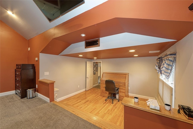 home office with vaulted ceiling and wood-type flooring