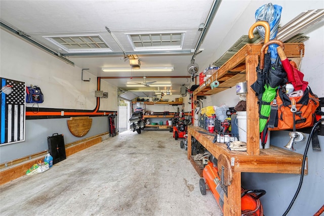 garage with a garage door opener and a workshop area