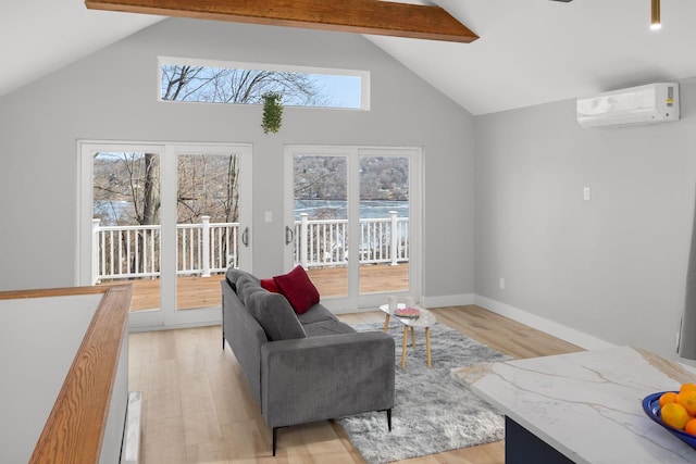 living room with a wall unit AC, beam ceiling, light wood-style floors, high vaulted ceiling, and baseboards