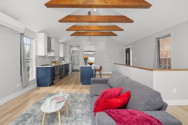 living room with vaulted ceiling with beams, light wood-style flooring, a wall mounted AC, and baseboards