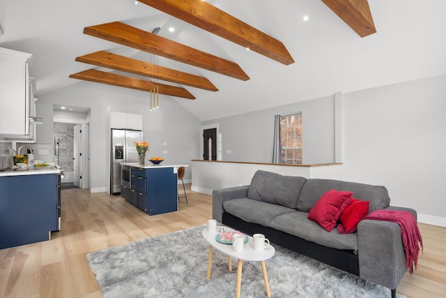 living area with lofted ceiling with beams, recessed lighting, light wood finished floors, and baseboards