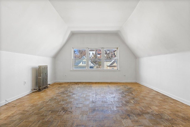 additional living space with lofted ceiling, radiator heating unit, and baseboards