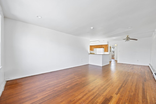 unfurnished living room with ceiling fan and dark hardwood / wood-style floors