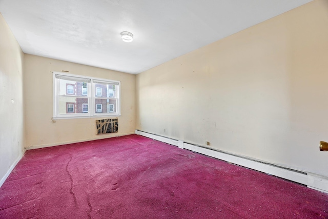 spare room with baseboard heating and carpet