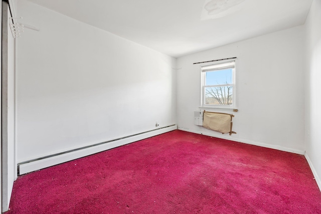 carpeted empty room featuring an AC wall unit and baseboard heating