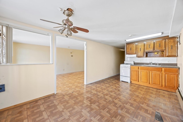 kitchen with white range with gas cooktop, sink, light parquet floors, and ceiling fan