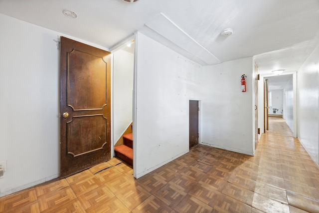 unfurnished room with parquet flooring