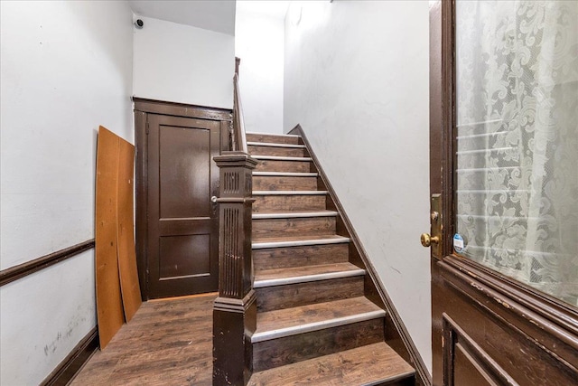 stairway featuring wood-type flooring