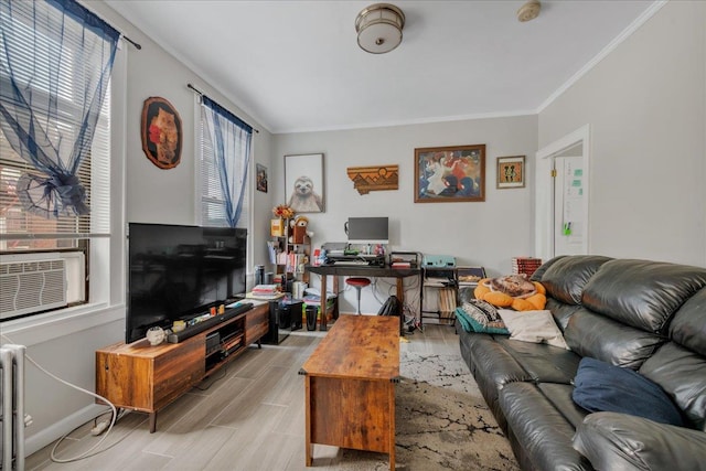 living room featuring crown molding, a healthy amount of sunlight, radiator heating unit, and light hardwood / wood-style floors