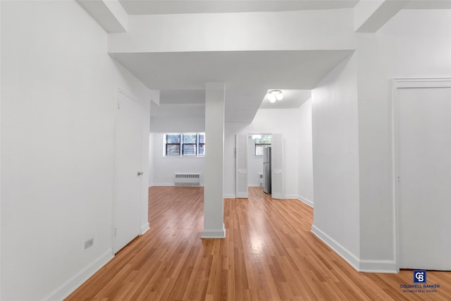 interior space featuring radiator and light hardwood / wood-style floors