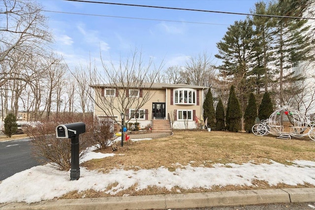 bi-level home featuring a lawn