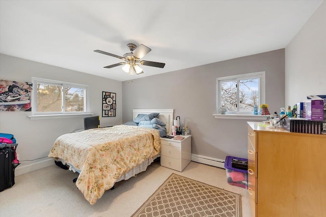 bedroom with a baseboard heating unit, light carpet, and ceiling fan