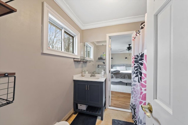 bathroom with crown molding, vanity, and ceiling fan