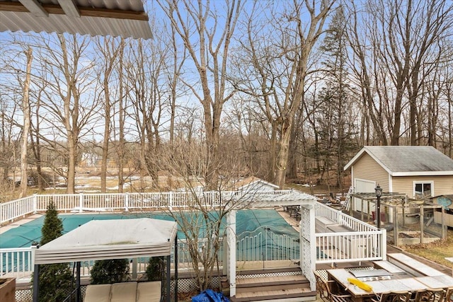 view of swimming pool with an outbuilding and a deck