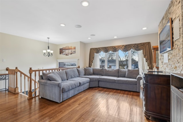 living room with dark hardwood / wood-style floors and a notable chandelier