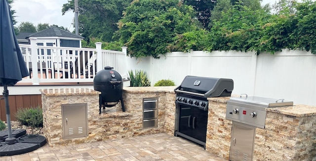 view of patio featuring grilling area and exterior kitchen