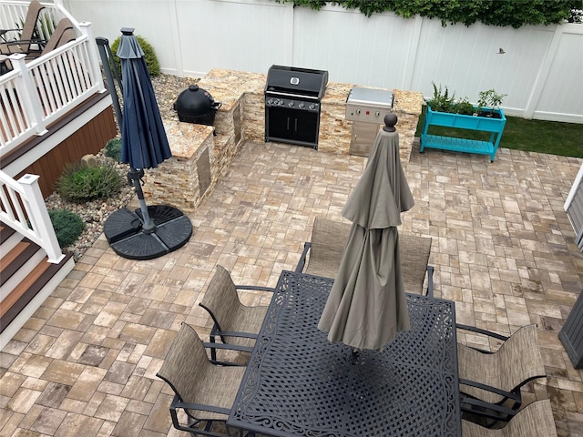 view of patio featuring area for grilling and a grill